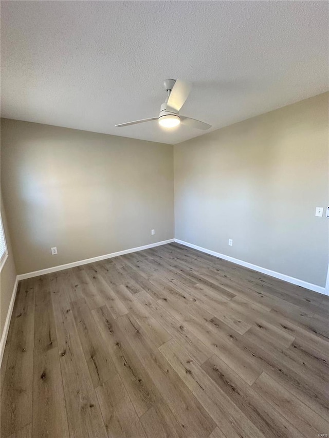 926 Justice Ct, Florissant, MO 63034 - empty room featuring wood finished floors, ceiling fan, a textured ceiling, and baseboards