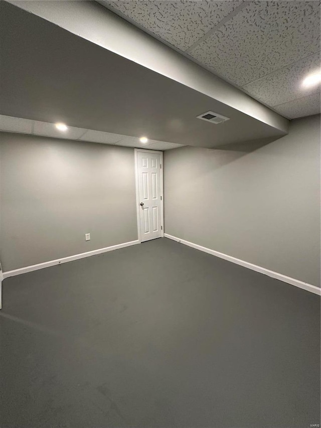 926 Justice Ct, Florissant, MO 63034 - finished below grade area with baseboards, a drop ceiling, and dark colored carpet