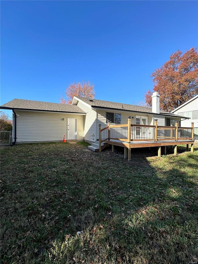 926 Justice Ct, Florissant, MO 63034 - back of property with a wooden deck, a yard, and a chimney