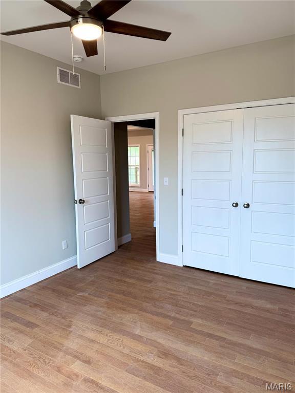 1905 Wheelwright Dr, Cape Girardeau, MO 63701 - unfurnished bedroom featuring baseboards, light wood finished floors, a closet, and ceiling fan