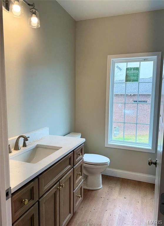 1905 Wheelwright Dr, Cape Girardeau, MO 63701 - bathroom with toilet, wood finished floors, vanity, and baseboards