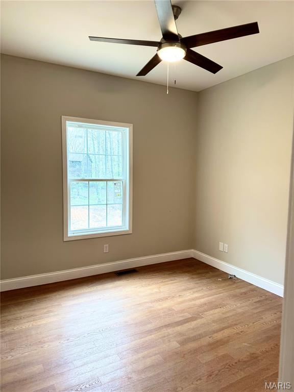 1905 Wheelwright Dr, Cape Girardeau, MO 63701 - spare room with a ceiling fan, wood finished floors, and baseboards