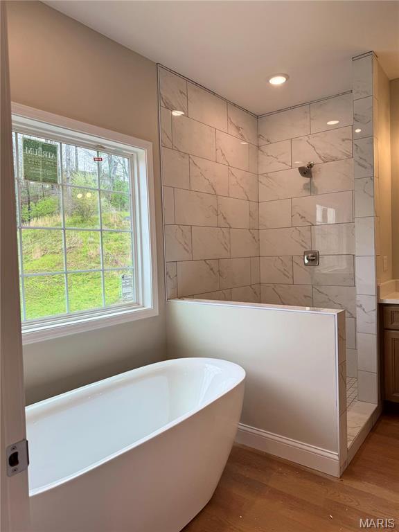 1905 Wheelwright Dr, Cape Girardeau, MO 63701 - bathroom featuring a freestanding bath, a walk in shower, wood finished floors, vanity, and recessed lighting
