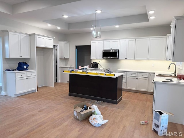 1905 Wheelwright Dr, Cape Girardeau, MO 63701 - kitchen featuring stainless steel microwave, a sink, light wood-type flooring, white cabinets, and recessed lighting