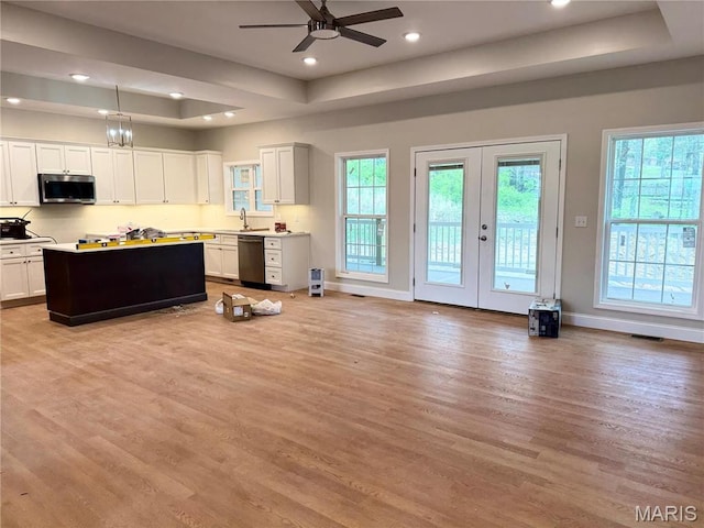 1905 Wheelwright Dr, Cape Girardeau, MO 63701 - kitchen with stainless steel microwave, dishwashing machine, a tray ceiling, light wood-type flooring, and recessed lighting