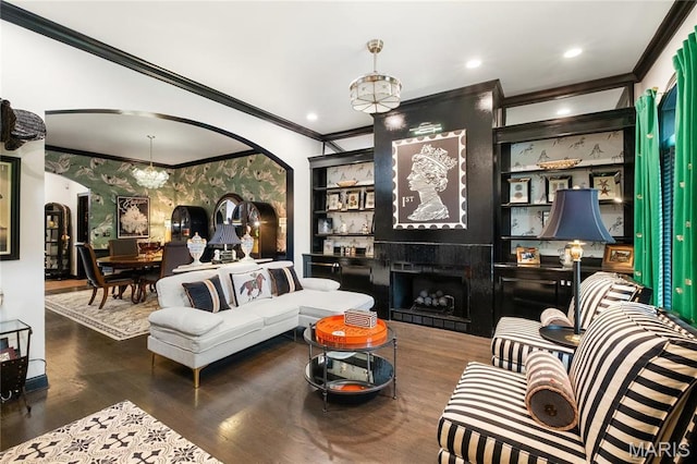 living room with arched walkways, ornamental molding, a fireplace, wood finished floors, and recessed lighting