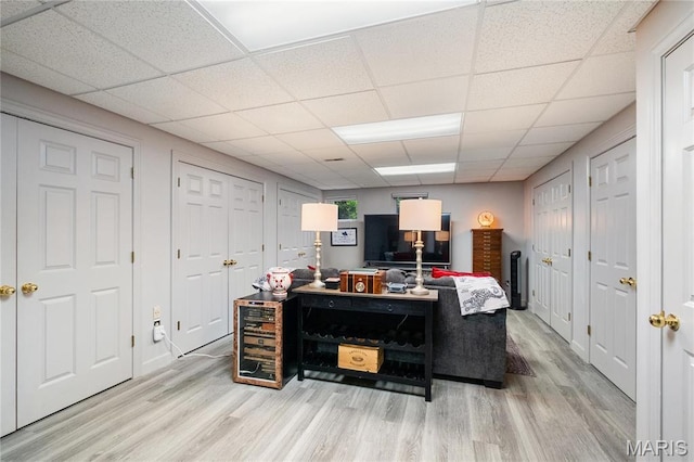 office space featuring light wood finished floors and a paneled ceiling