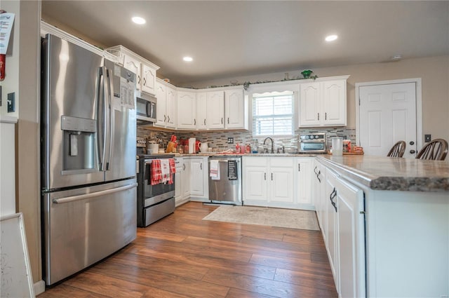 203 Borth St, Doniphan, MO 63935 - kitchen with stainless steel appliances, white cabinets, a peninsula, backsplash, and recessed lighting