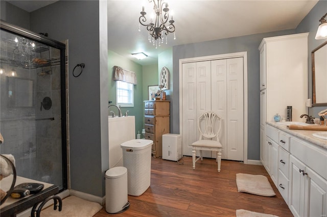 203 Borth St, Doniphan, MO 63935 - bathroom featuring a stall shower, wood finished floors, double vanity, and baseboards