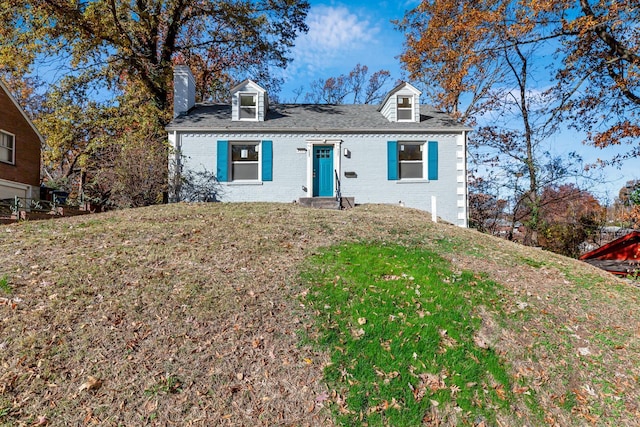 4327 Nelson Dr, Saint Louis, MO 63121 - view of front of house with brick siding, a chimney, a front yard, and roof with shingles
