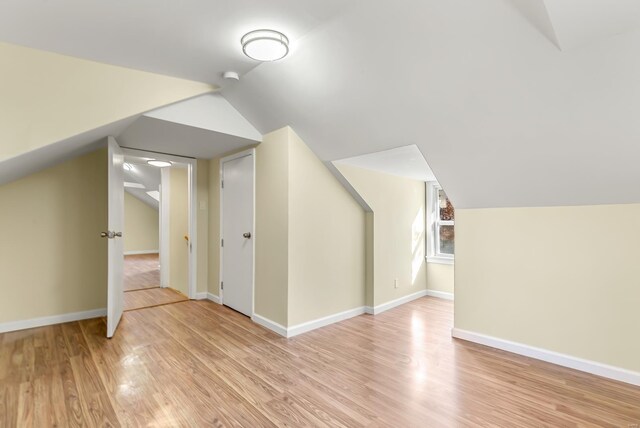 4327 Nelson Dr, Saint Louis, MO 63121 - additional living space featuring light wood-style floors, vaulted ceiling, and baseboards