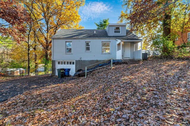 4327 Nelson Dr, Saint Louis, MO 63121 - back of property with a garage, fence, central air condition unit, a shingled roof, and asphalt driveway
