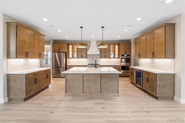 19 Beaver Dr, Creve Coeur, MO 63141 - kitchen with stainless steel appliances, premium range hood, wine cooler, backsplash, and recessed lighting