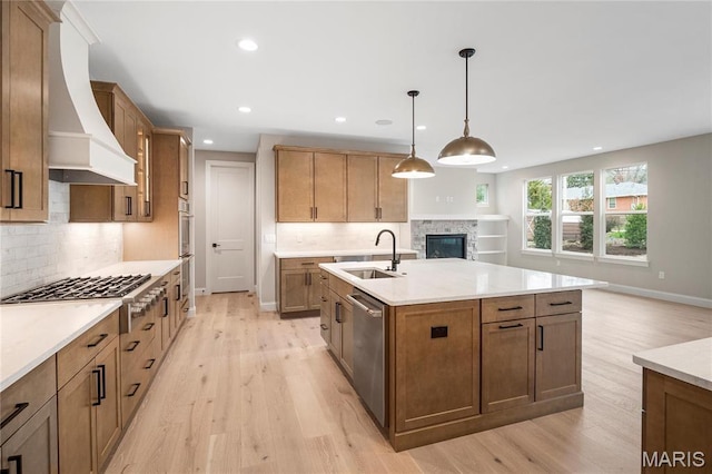 19 Beaver Dr, Creve Coeur, MO 63141 - kitchen featuring a sink, premium range hood, stainless steel appliances, light wood-style floors, and recessed lighting