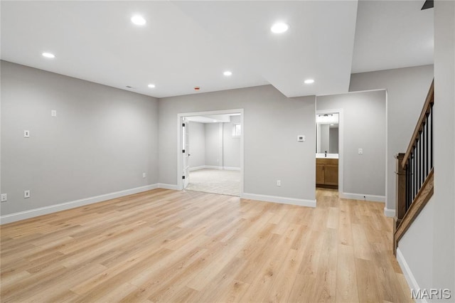 19 Beaver Dr, Creve Coeur, MO 63141 - unfurnished living room with stairway, light wood-style flooring, recessed lighting, and baseboards