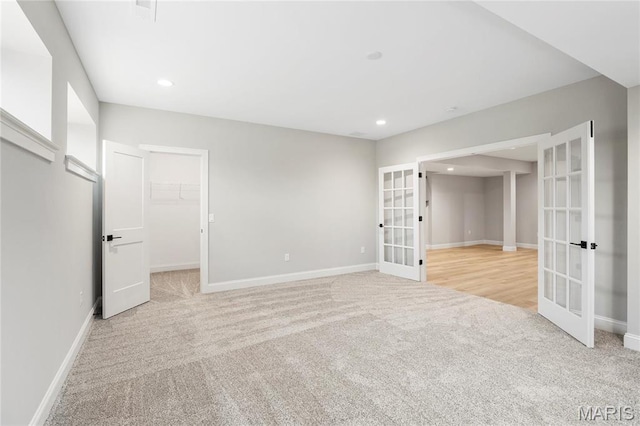 19 Beaver Dr, Creve Coeur, MO 63141 - unfurnished bedroom featuring french doors, light colored carpet, baseboards, recessed lighting, and a spacious closet
