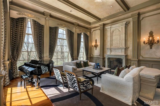 1290 Dry Ridge Rd, Town And Country, MO 63131 - living area featuring a decorative wall, ornamental molding, beamed ceiling, a premium fireplace, and wood finished floors
