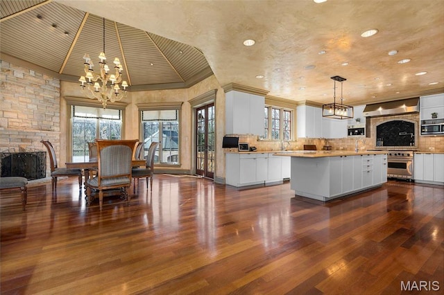 1290 Dry Ridge Rd, Town And Country, MO 63131 - kitchen with a chandelier, wall oven, a fireplace, dark wood finished floors, and plenty of natural light