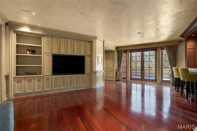 1290 Dry Ridge Rd, Town And Country, MO 63131 - unfurnished living room with crown molding, french doors, dark wood-style flooring, built in features, and a decorative wall