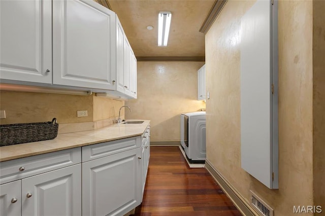 1290 Dry Ridge Rd, Town And Country, MO 63131 - laundry area with washer / clothes dryer, cabinet space, dark wood-type flooring, and crown molding