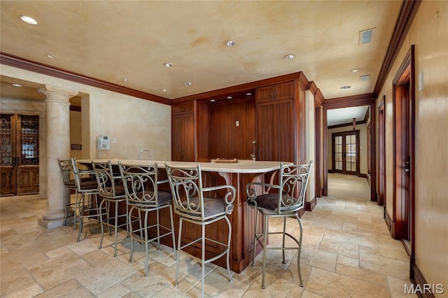 1290 Dry Ridge Rd, Town And Country, MO 63131 - bar area featuring stone tile flooring, crown molding, recessed lighting, and ornate columns