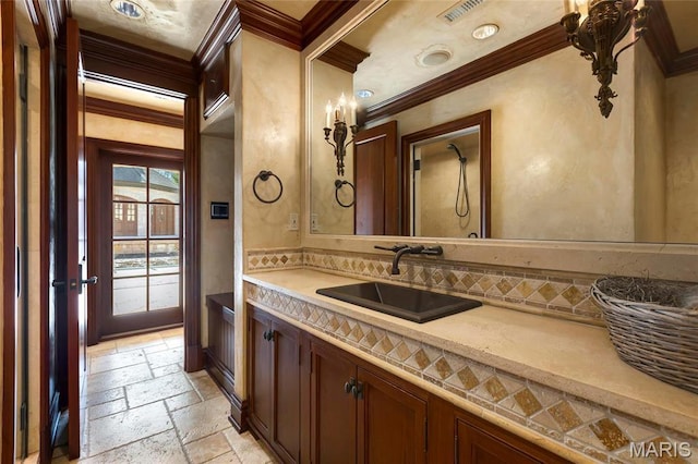 1290 Dry Ridge Rd, Town And Country, MO 63131 - bathroom featuring crown molding, stone tile flooring, vanity, and decorative backsplash