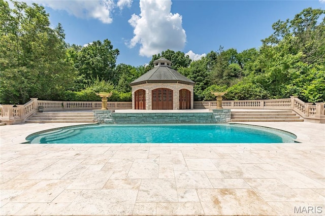 1290 Dry Ridge Rd, Town And Country, MO 63131 - outdoor pool with a deck, a patio, and view of wooded area