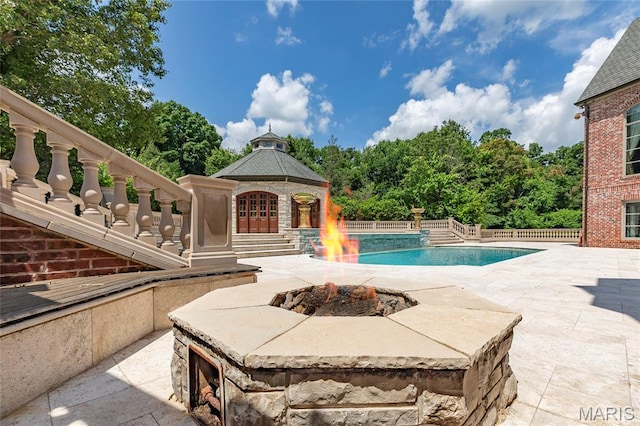 1290 Dry Ridge Rd, Town And Country, MO 63131 - view of pool featuring an outdoor fire pit, a patio, and a fenced backyard
