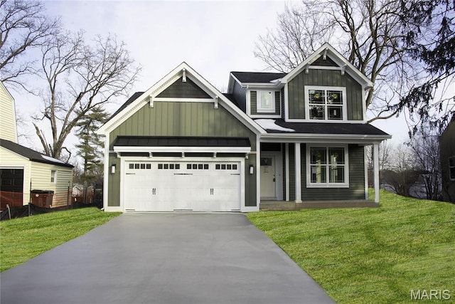 710 Angenette Ave, Kirkwood, MO 63122 - view of front of home featuring board and batten siding, asphalt driveway, and a front yard