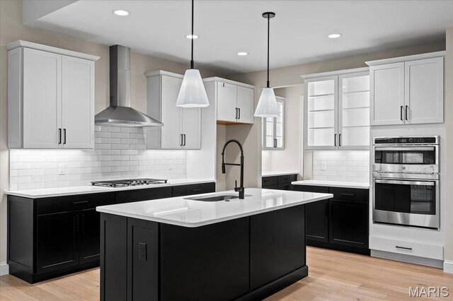 710 Angenette Ave, Kirkwood, MO 63122 - kitchen with wall chimney range hood, a sink, gas stovetop, dark cabinetry, and recessed lighting