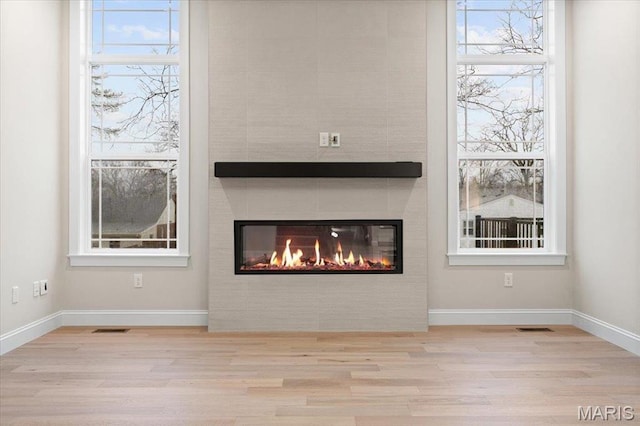 710 Angenette Ave, Kirkwood, MO 63122 - detailed view of wood finished floors, a fireplace, and baseboards