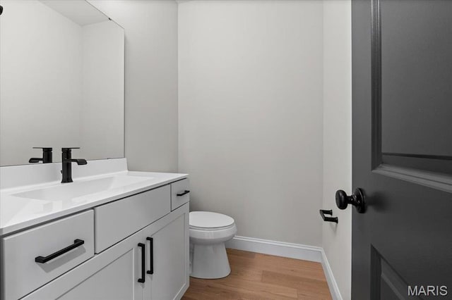 710 Angenette Ave, Kirkwood, MO 63122 - bathroom with wood finished floors, baseboards, vanity, and toilet