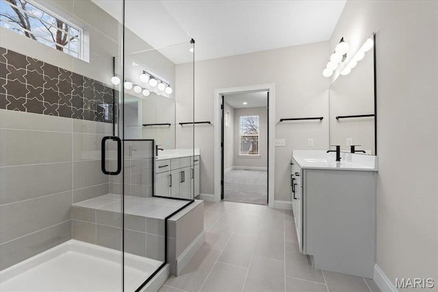 710 Angenette Ave, Kirkwood, MO 63122 - bathroom with a stall shower, two vanities, baseboards, and tile patterned floors