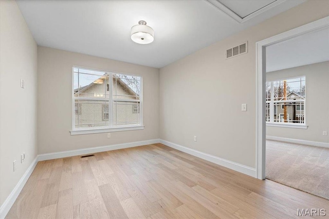 710 Angenette Ave, Kirkwood, MO 63122 - empty room with plenty of natural light, light wood-style floors, and baseboards