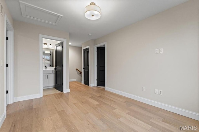 710 Angenette Ave, Kirkwood, MO 63122 - unfurnished bedroom with light wood-style flooring, baseboards, and attic access