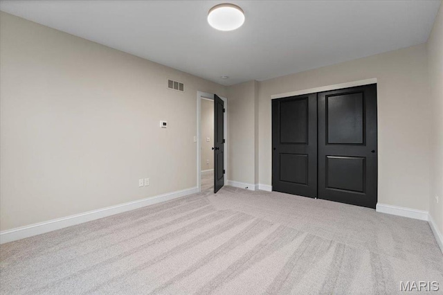710 Angenette Ave, Kirkwood, MO 63122 - unfurnished bedroom with light carpet, baseboards, and a closet