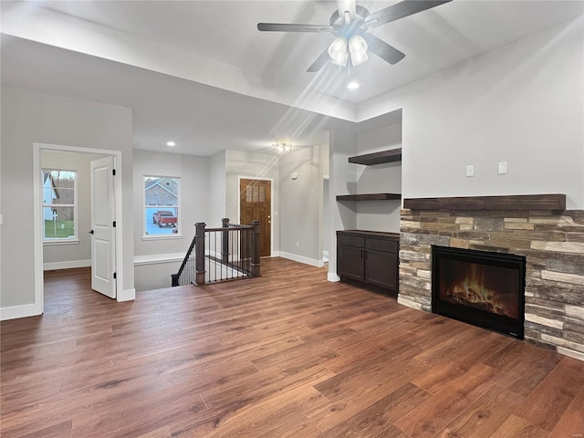 205 Stonebridge Bluff Dr, Maryville, IL 62062 - unfurnished living room featuring wood finished floors, baseboards, a ceiling fan, a stone fireplace, and recessed lighting