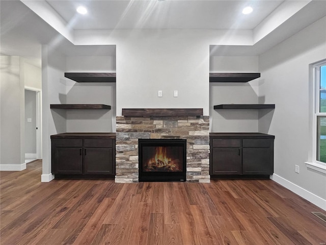 205 Stonebridge Bluff Dr, Maryville, IL 62062 - unfurnished living room featuring dark wood-style flooring, baseboards, a fireplace, and healthy amount of natural light