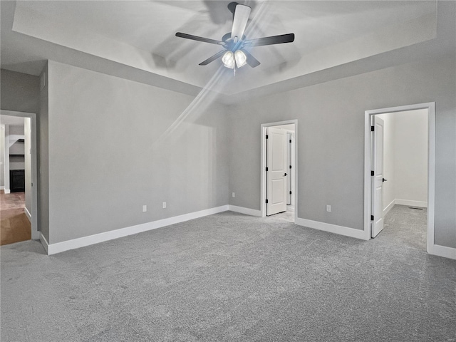 205 Stonebridge Bluff Dr, Maryville, IL 62062 - unfurnished bedroom with a raised ceiling, carpet flooring, baseboards, and a ceiling fan