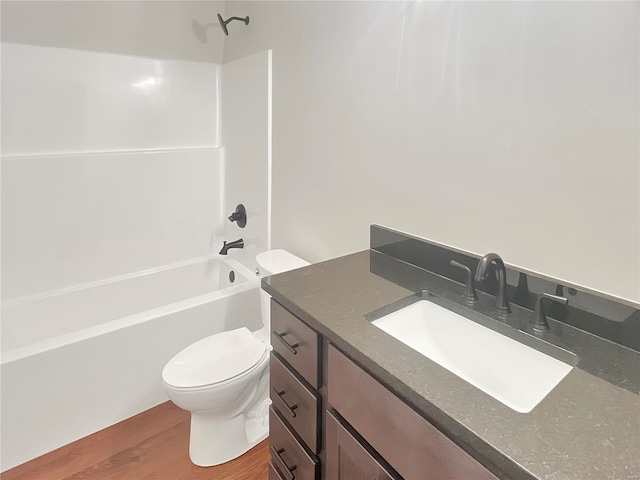 205 Stonebridge Bluff Dr, Maryville, IL 62062 - bathroom featuring toilet, wood finished floors, vanity, and bathing tub / shower combination