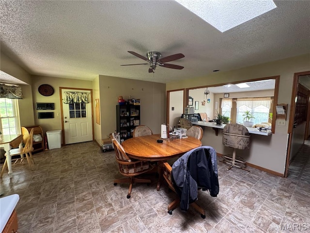 9747 Wayne Route P, Mcgee, MO 63763 - dining room with a textured ceiling, ceiling fan, a skylight, and baseboards