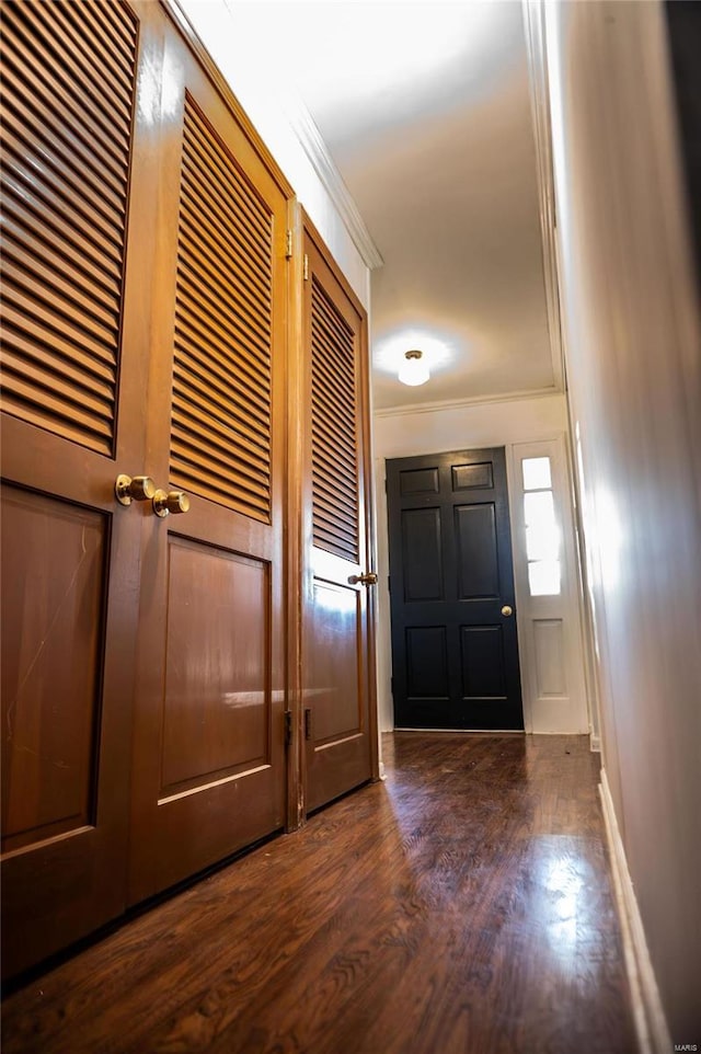 entryway featuring ornamental molding and dark wood finished floors