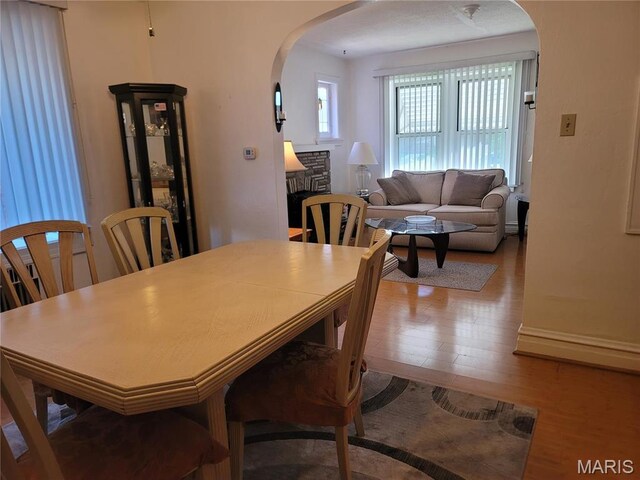 4877 Calvin Ave, Saint Louis, MO 63115 - dining space featuring arched walkways and wood finished floors