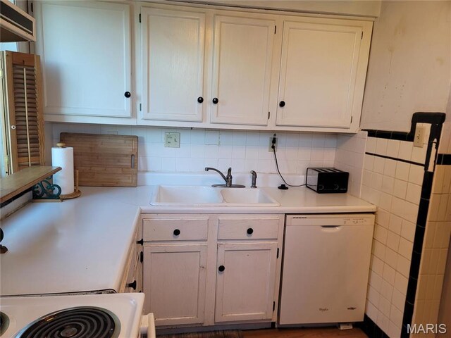 4877 Calvin Ave, Saint Louis, MO 63115 - kitchen with dishwasher, a sink, white cabinets, light countertops, and backsplash