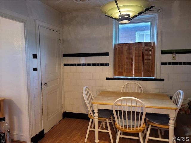 4877 Calvin Ave, Saint Louis, MO 63115 - dining area featuring tile walls and wood finished floors
