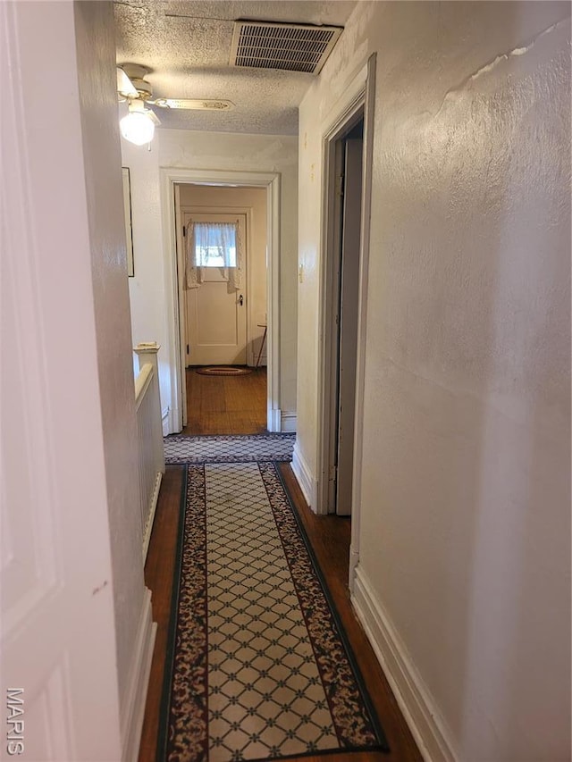 4877 Calvin Ave, Saint Louis, MO 63115 - hallway featuring baseboards and dark wood-style flooring