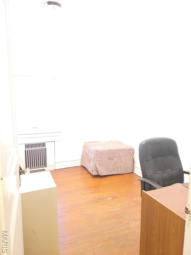 4877 Calvin Ave, Saint Louis, MO 63115 - bedroom featuring radiator and light wood-style flooring