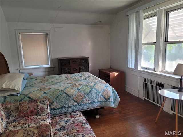 4877 Calvin Ave, Saint Louis, MO 63115 - bedroom featuring radiator heating unit, wood finished floors, and lofted ceiling