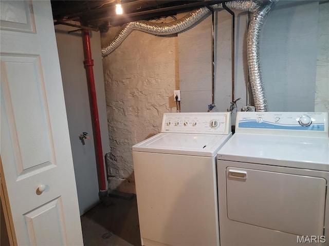 4877 Calvin Ave, Saint Louis, MO 63115 - clothes washing area with washing machine and clothes dryer