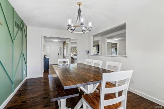 825 Cimarron Cir, Farmington, MO 63640 - dining space featuring a chandelier, baseboards, and dark wood-type flooring